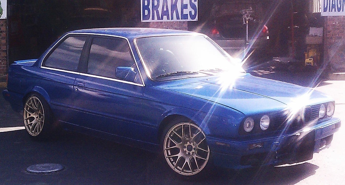 Blue coupe fitted with custom wheels