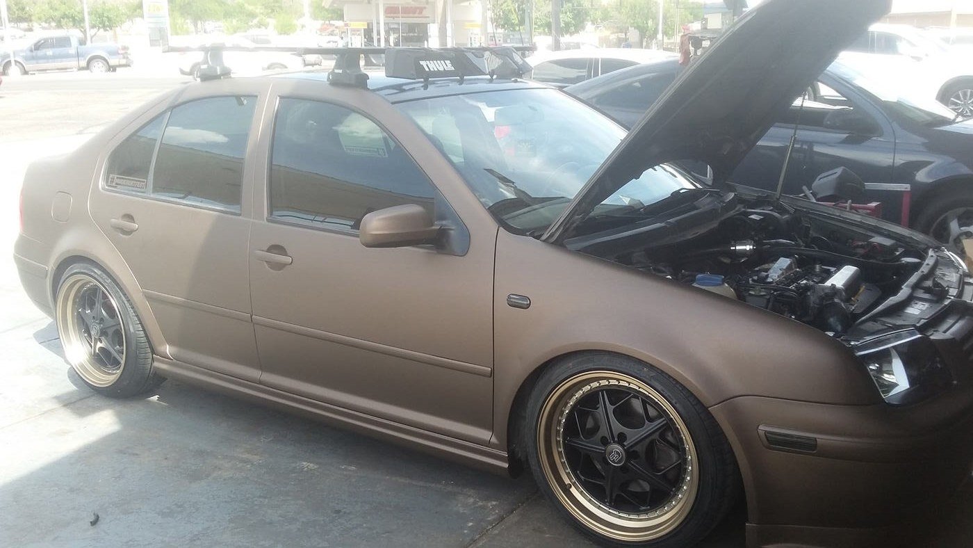 Matte bronze hatchback fitted with custom wheels