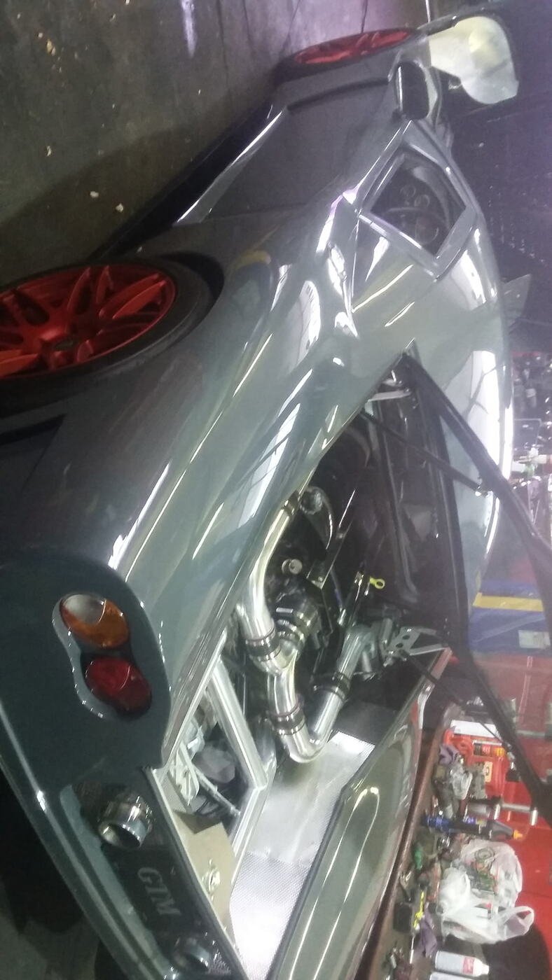 Sports car engine bay with custom intercooler piping