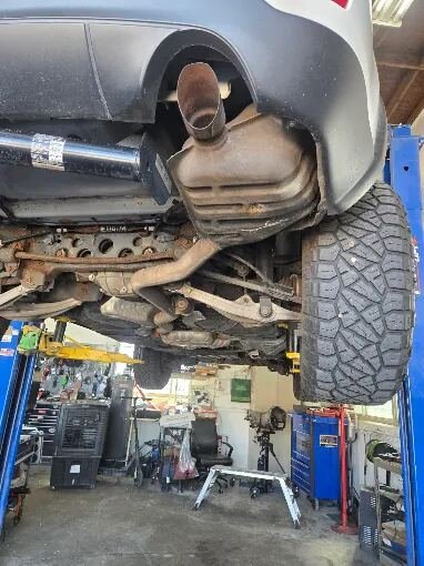 Undercarriage and exhaust work on a lift